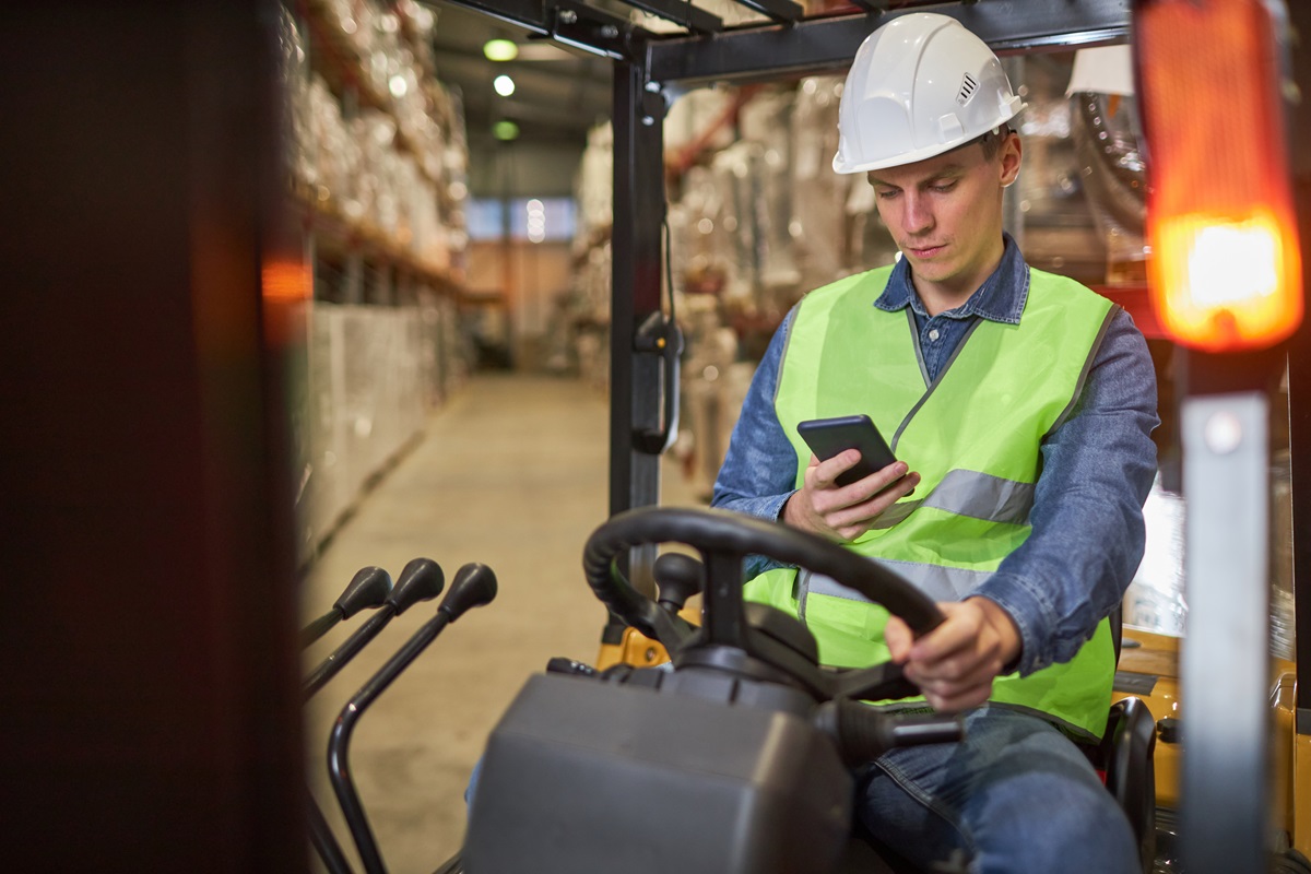Worker using a forklift inspection app