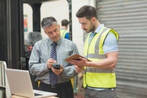 Businessman reviewing safety procedures with a contractor